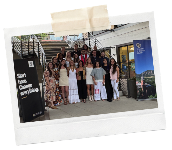 Polaroid of a graduate design class posing together outside a CU Boulder building